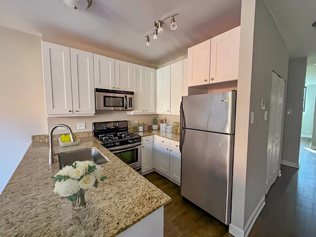 a kitchen with a refrigerator stove and microwave