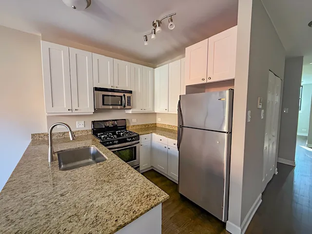 a kitchen with a refrigerator sink and stove