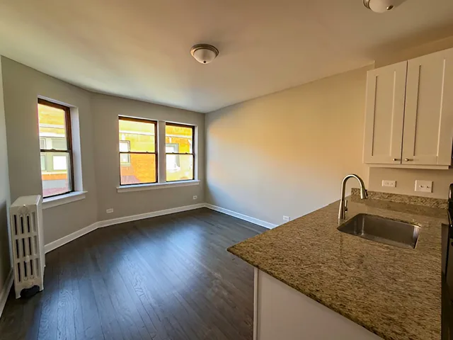 a kitchen with sink wooden floor and window