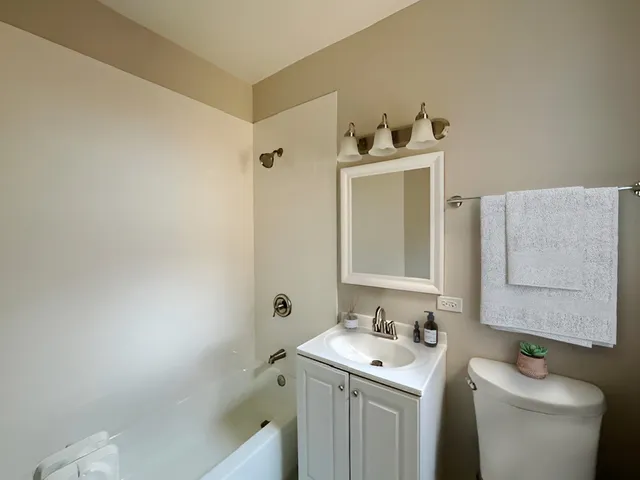 a bathroom with a sink toilet and vanity