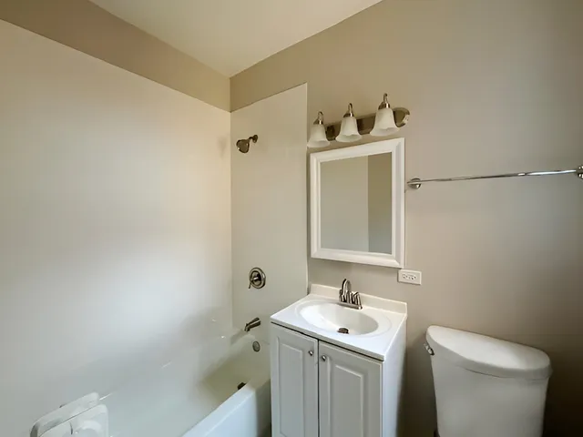 a bathroom with a sink toilet and vanity