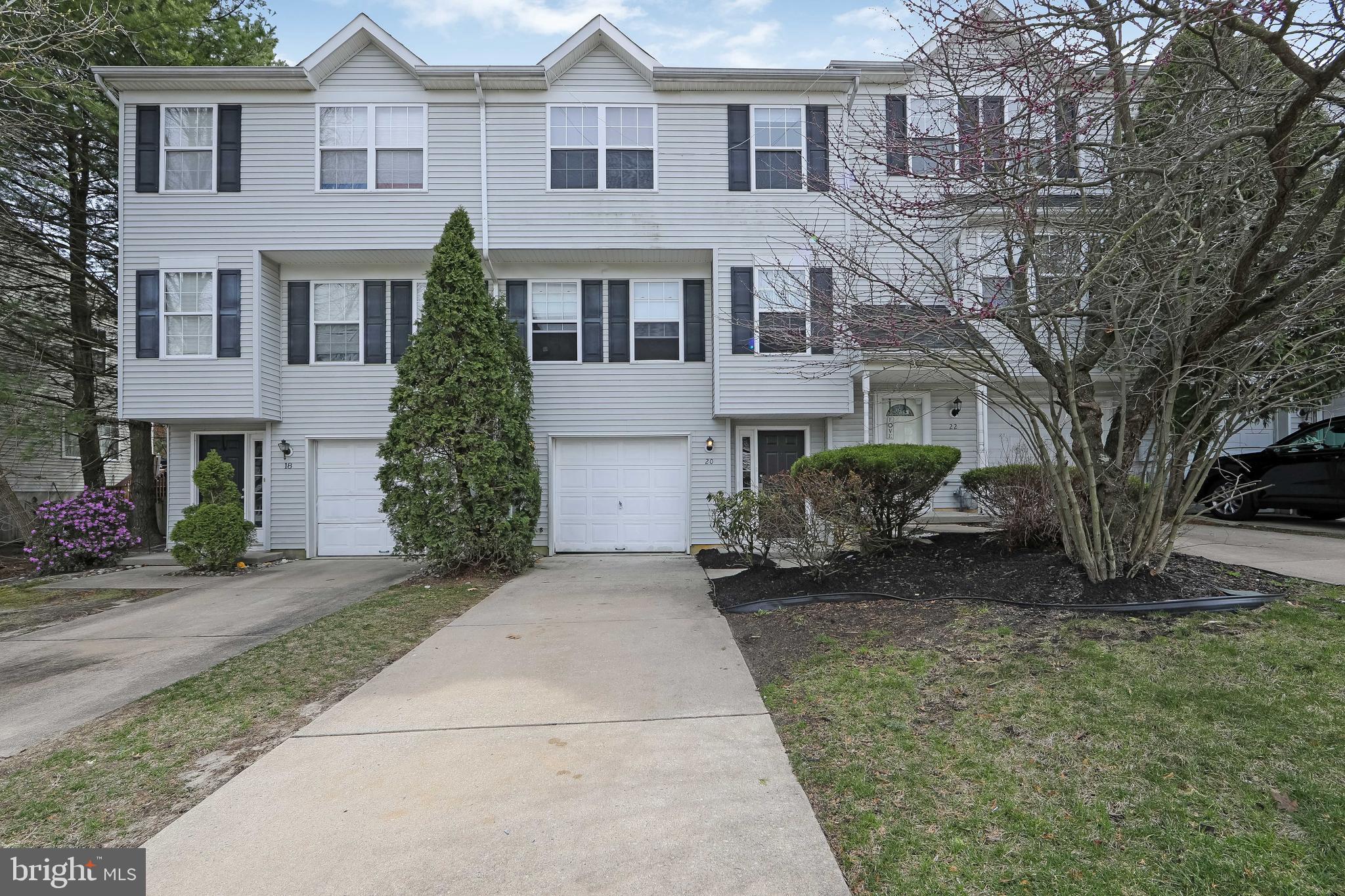 a front view of a house with a yard and a garage