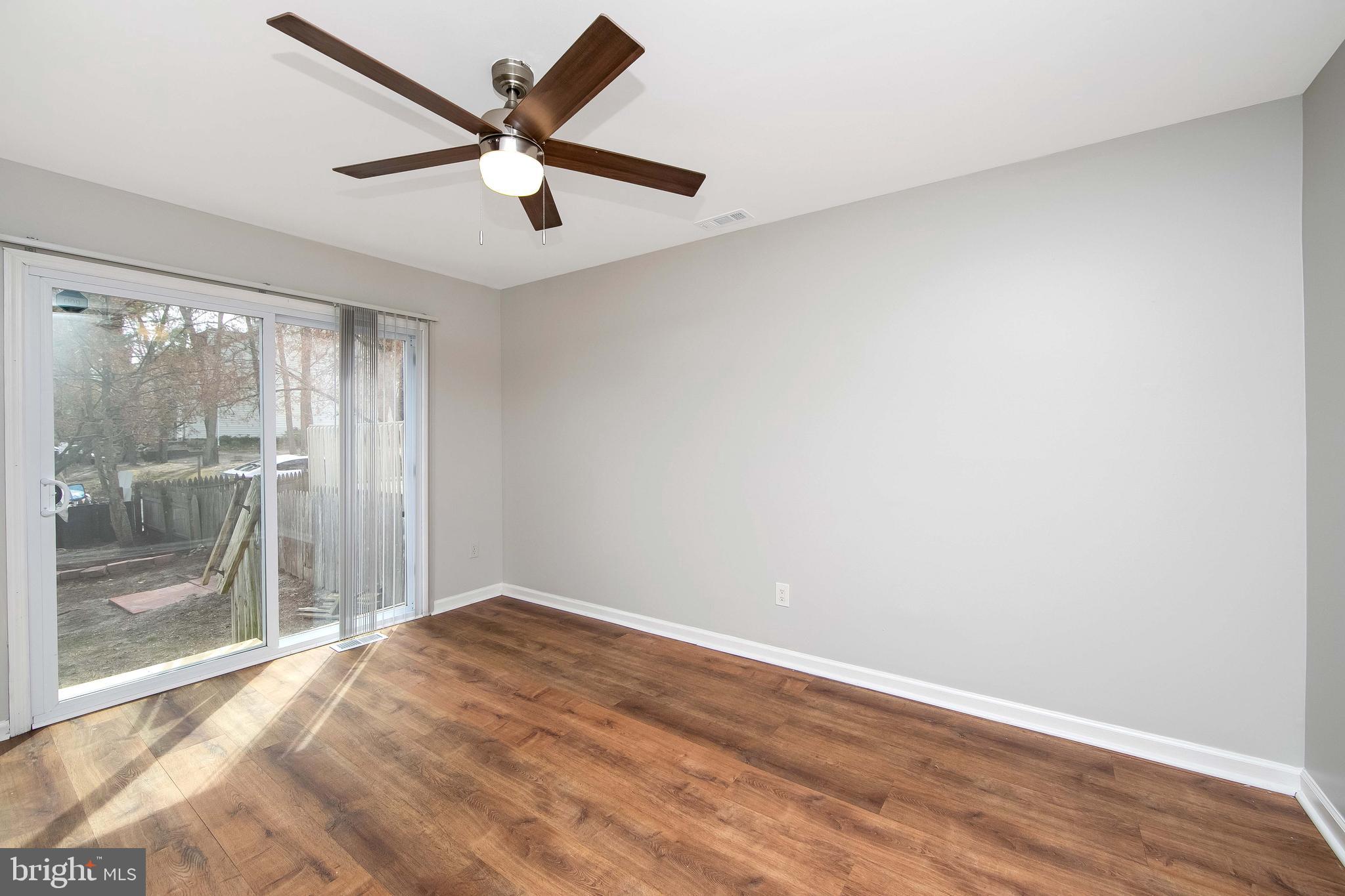 20 Gristmill Lane Pine Hill, NJ 08021 - Photo 11 of 37 an empty room with wooden floor and windows