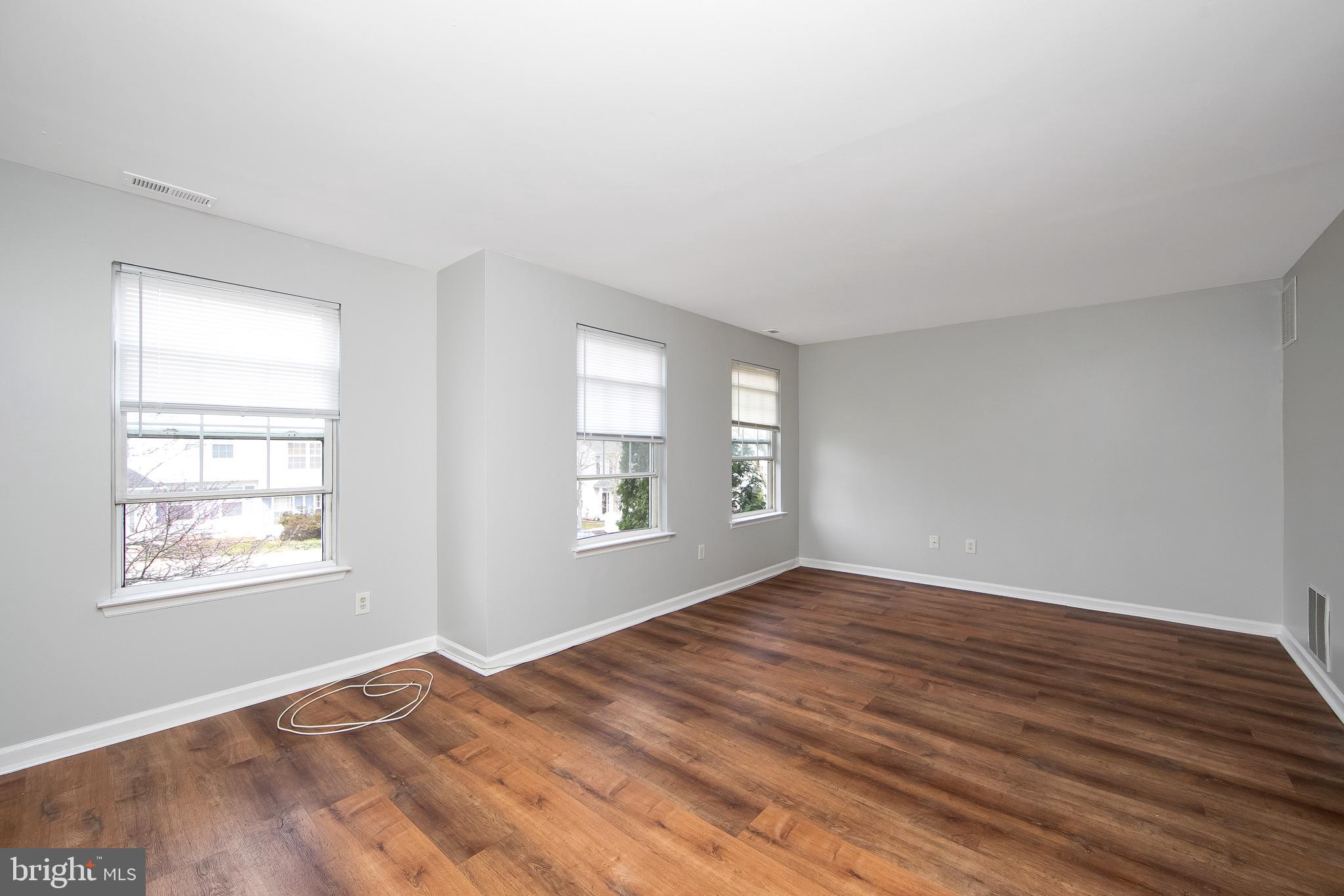 20 Gristmill Lane Pine Hill, NJ 08021 - Photo 13 of 37 a view of an empty room with wooden floor and a window