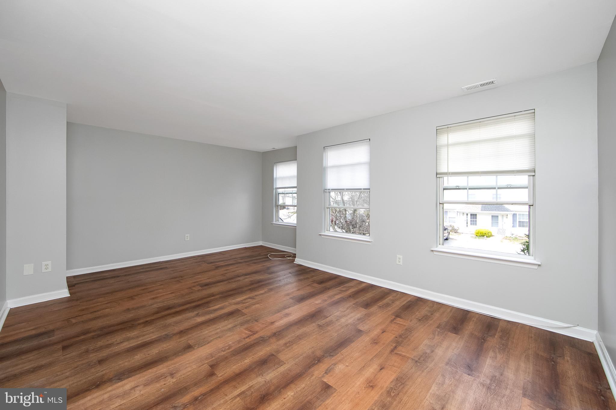 20 Gristmill Lane Pine Hill, NJ 08021 - Photo 15 of 37 an empty room with wooden floor and windows