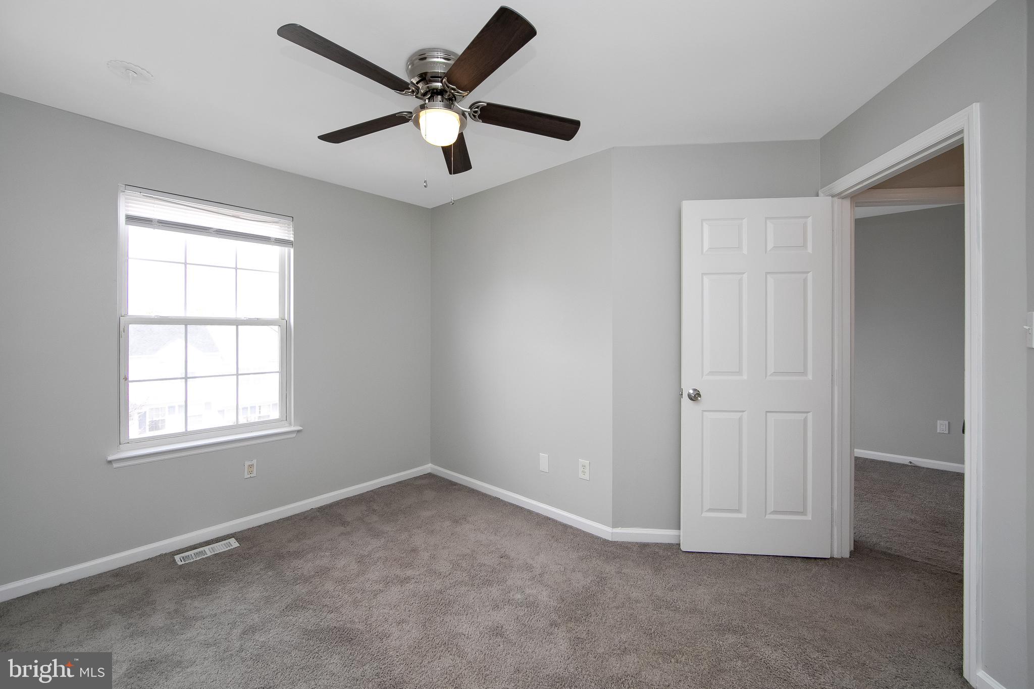 20 Gristmill Lane Pine Hill, NJ 08021 - Photo 29 of 37 an empty room with chandelier fan and windows