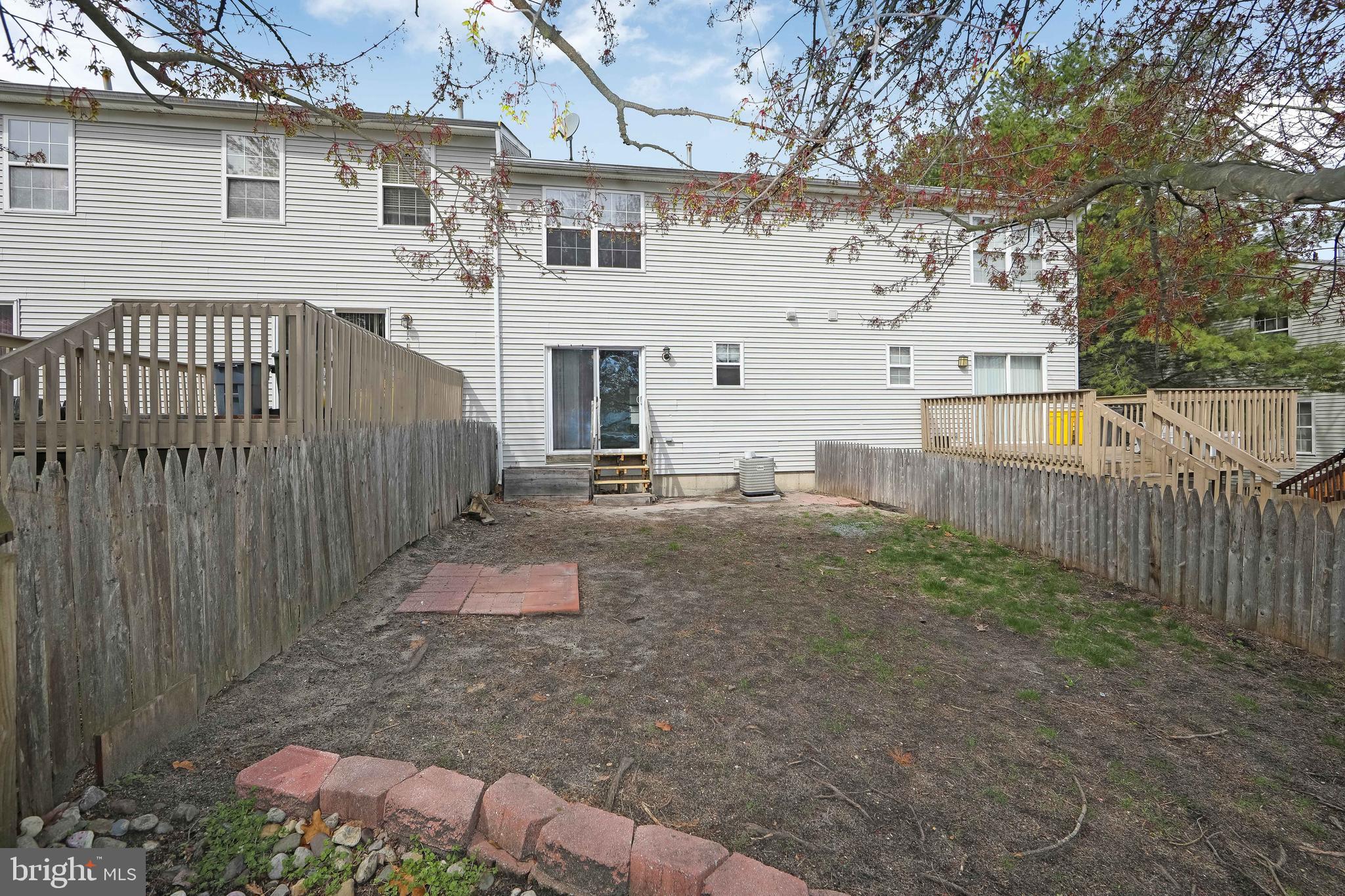 20 Gristmill Lane Pine Hill, NJ 08021 - Photo 35 of 37 a view of a white house with a small yard and wooden fence
