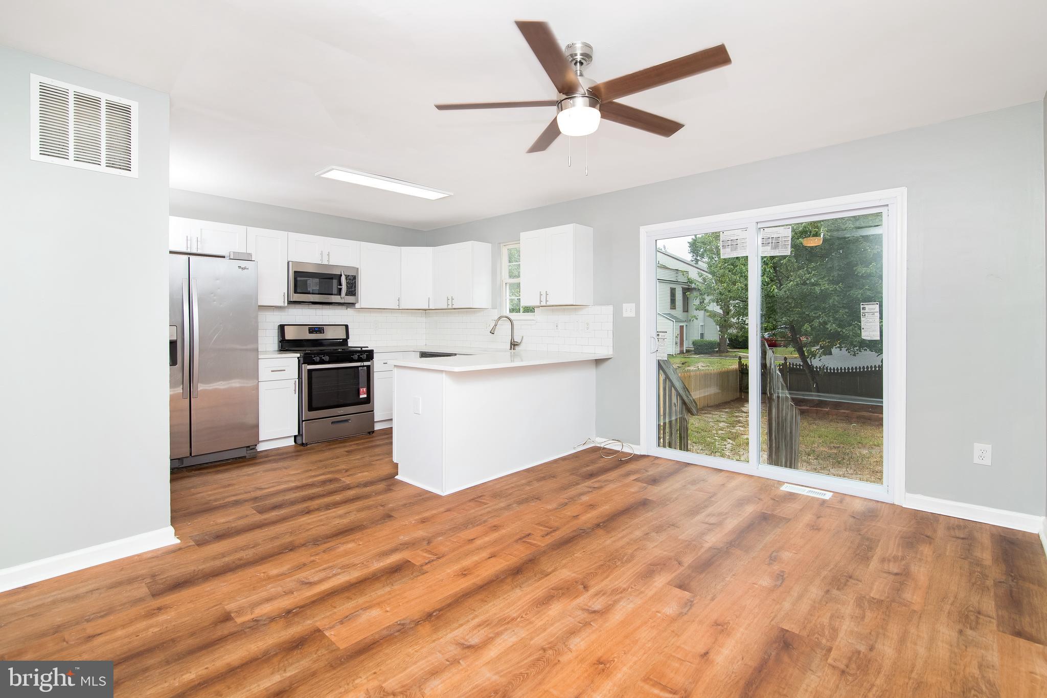20 Gristmill Lane Pine Hill, NJ 08021 - Photo 5 of 37 a kitchen with stainless steel appliances kitchen island a refrigerator sink and stove