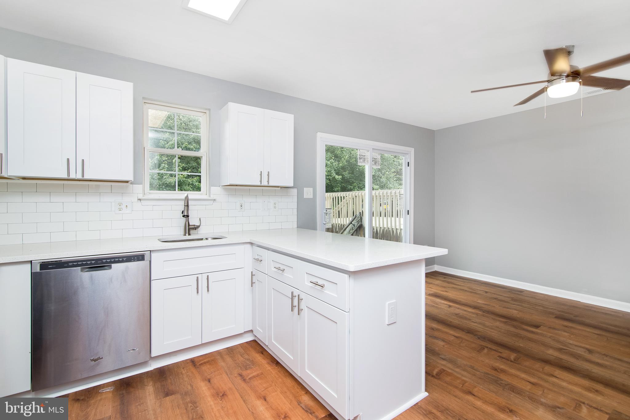 20 Gristmill Lane Pine Hill, NJ 08021 - Photo 7 of 37 a kitchen with white cabinets and sink