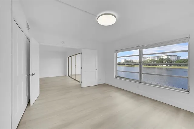 an empty room with large windows