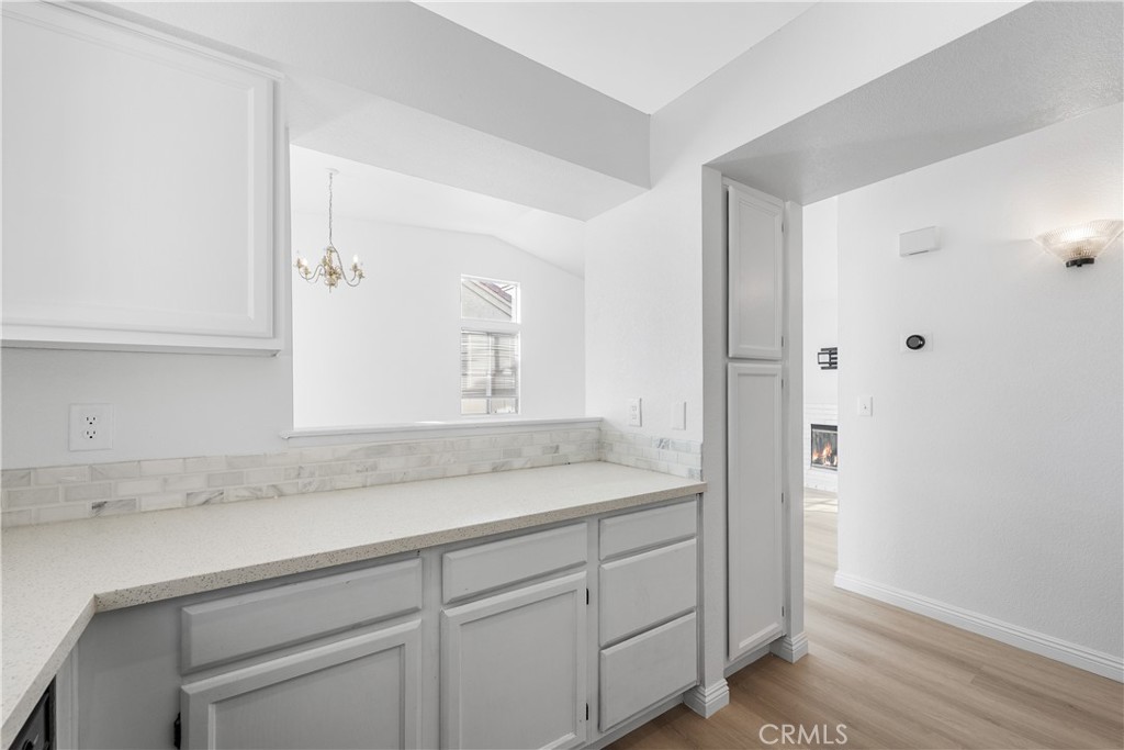 3209 Titcher Lane Rosamond, CA 93560 - Photo 17 of 36 a bathroom with a granite countertop sink and white cabinets