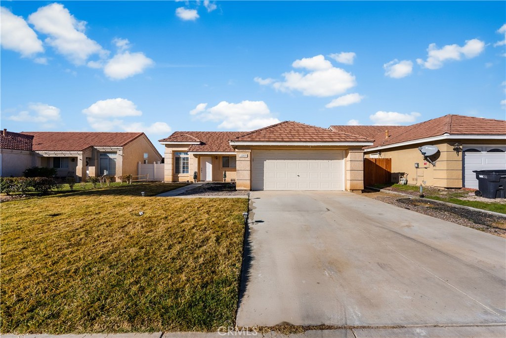 3209 Titcher Lane Rosamond, CA 93560 - Photo 2 of 36 a front view of a house with a yard