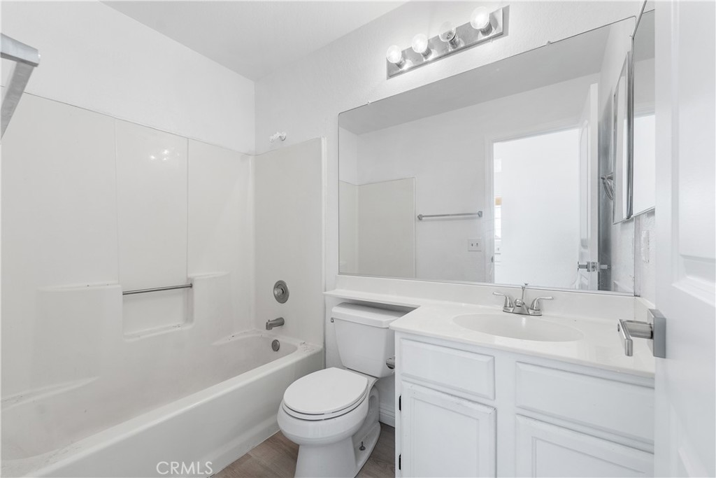 3209 Titcher Lane Rosamond, CA 93560 - Photo 21 of 36 a bathroom with a sink toilet a mirror and shower