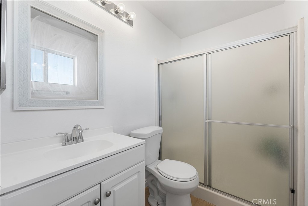 3209 Titcher Lane Rosamond, CA 93560 - Photo 27 of 36 a bathroom with a sink toilet and vanity