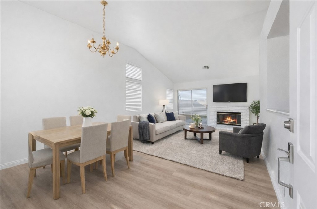 3209 Titcher Lane Rosamond, CA 93560 - Photo 3 of 36 a living room with furniture a fireplace and a flat screen tv