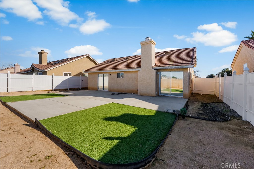 3209 Titcher Lane Rosamond, CA 93560 - Photo 32 of 36 a view of a white house with a swimming pool and yard