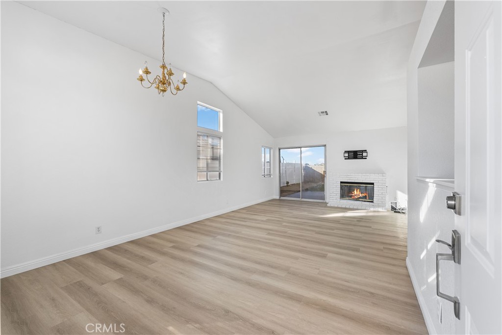 3209 Titcher Lane Rosamond, CA 93560 - Photo 4 of 36 a view of an empty room with wooden floor and a window