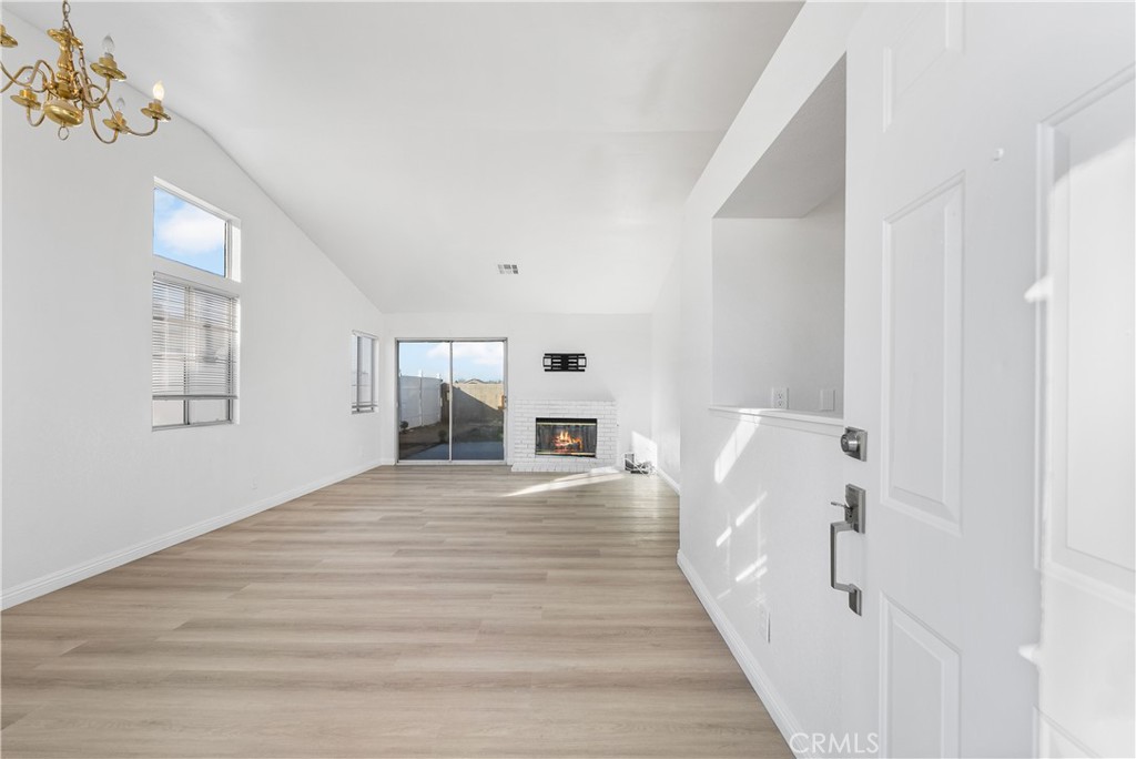 3209 Titcher Lane Rosamond, CA 93560 - Photo 6 of 36 a view of a hallway with wooden floor and staircase