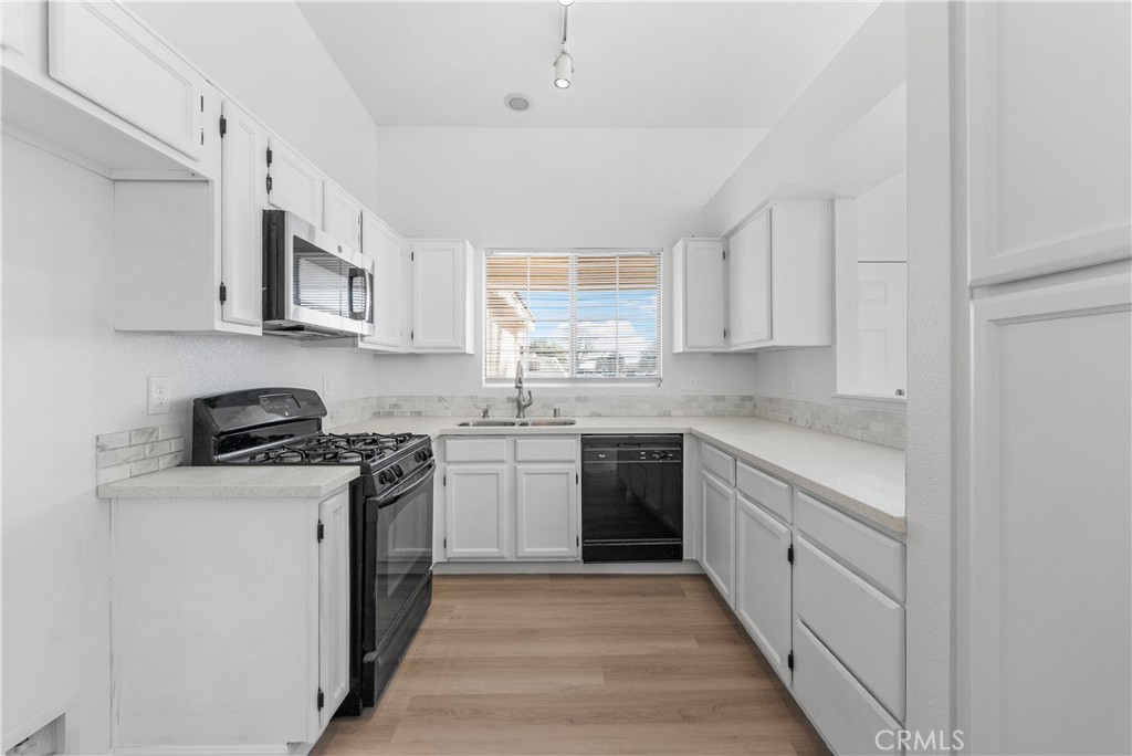 3209 Titcher Lane Rosamond, CA 93560 - Photo 9 of 36 a kitchen with stainless steel appliances granite countertop a stove a sink dishwasher and a refrigerator