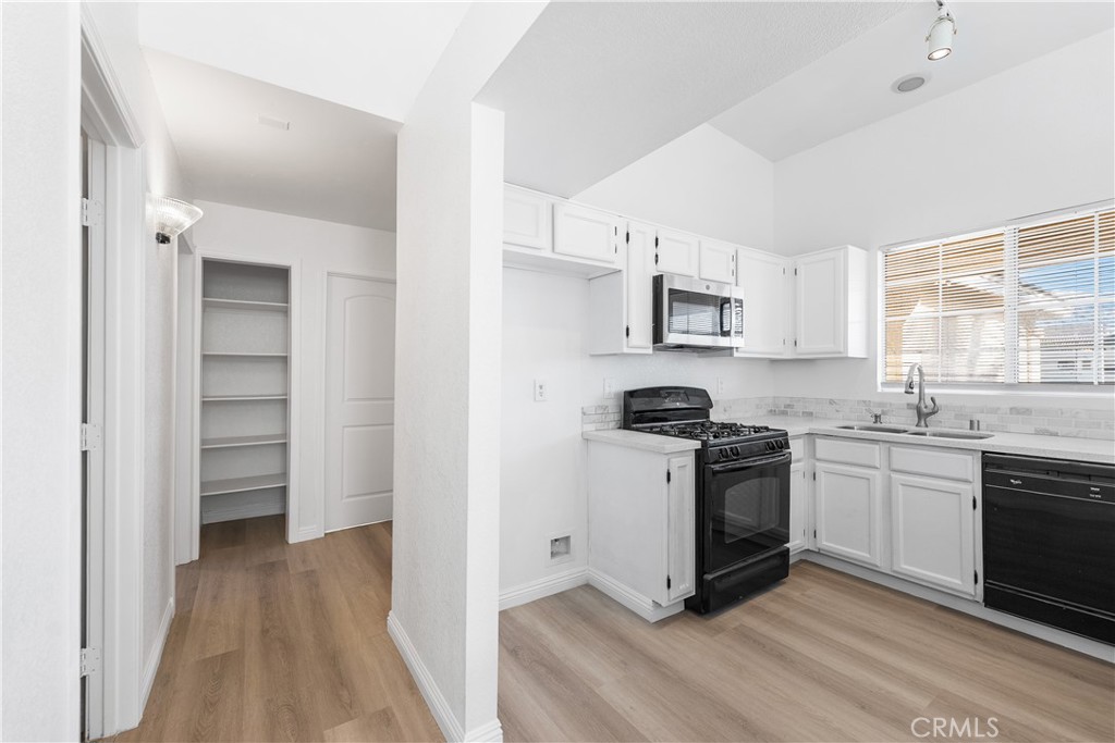 3209 Titcher Lane Rosamond, CA 93560 - Photo 10 of 36 a kitchen with stainless steel appliances granite countertop a stove a sink and a refrigerator