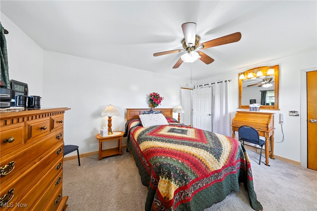 5834 Dickson Road New Washington, OH 44854 - Photo 24 of 40 Bedroom with light colored carpet and ceiling fan