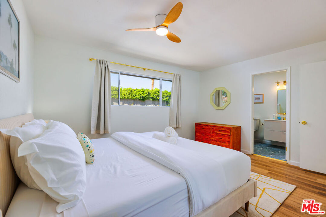 1250 East Delgado Road Palm Springs, CA 92262 - Photo 16 of 30 a bedroom with a bed and a chandelier