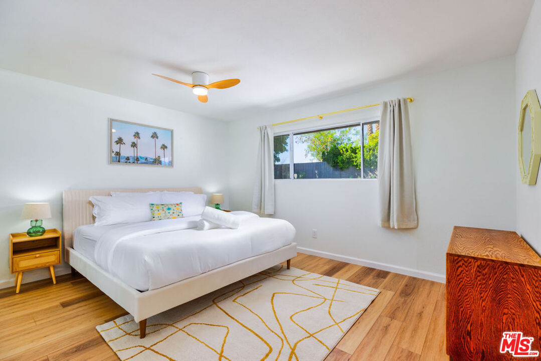1250 East Delgado Road Palm Springs, CA 92262 - Photo 17 of 30 a bedroom with a bed and wooden floor