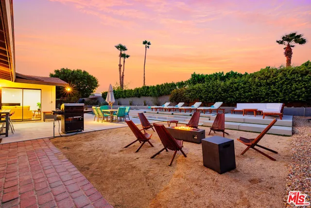 a view of a swimming pool with an outdoor seating