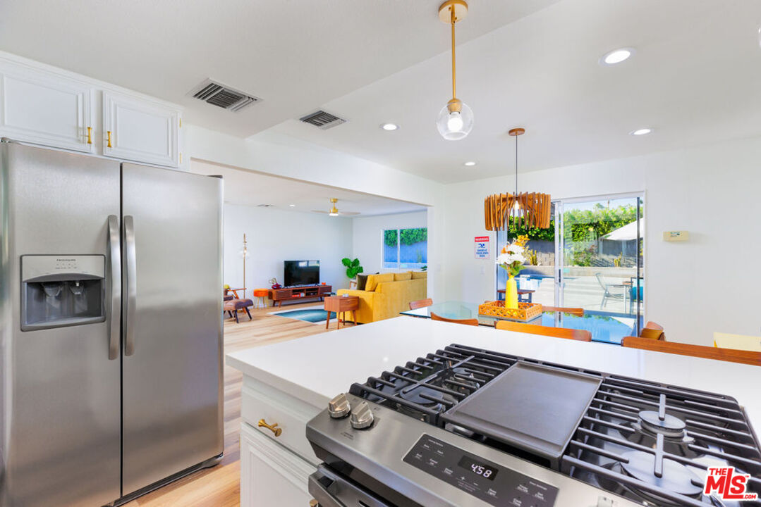 1250 East Delgado Road Palm Springs, CA 92262 - Photo 8 of 30 a kitchen with stainless steel appliances kitchen island a stove and a refrigerator