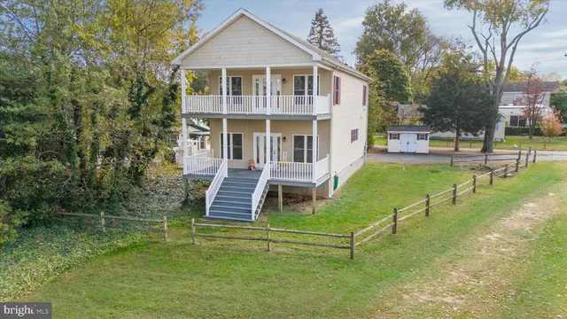 a front view of a house with a yard table and chairs