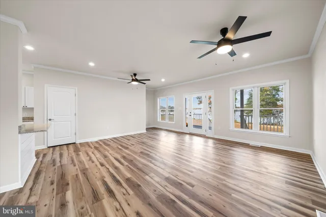a kitchen with granite countertop white cabinets and stainless steel appliances