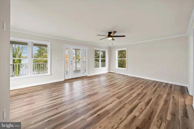 wooden floor in an empty room with a window
