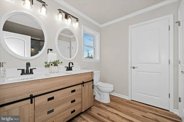a bathroom with a double vanity sink and a mirror