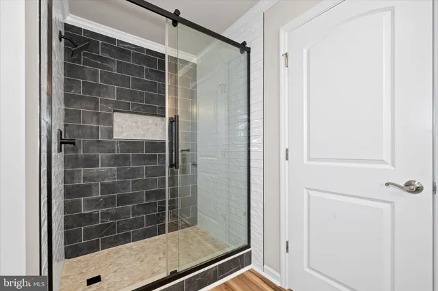 an empty room with wooden floor and fence