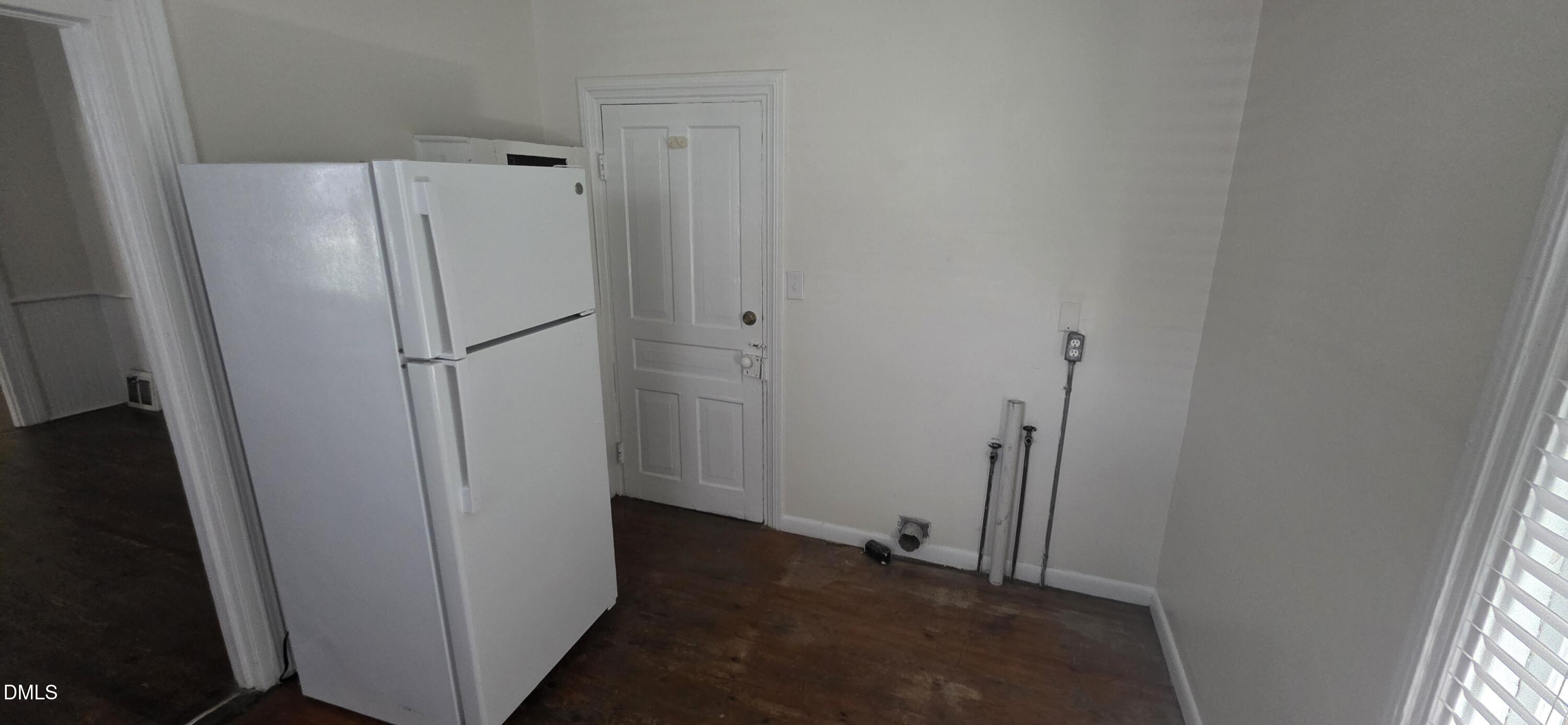 509 North East Street Raleigh, NC 27604 - Photo 13 of 18 a view of a kitchen with refrigerator and white wall