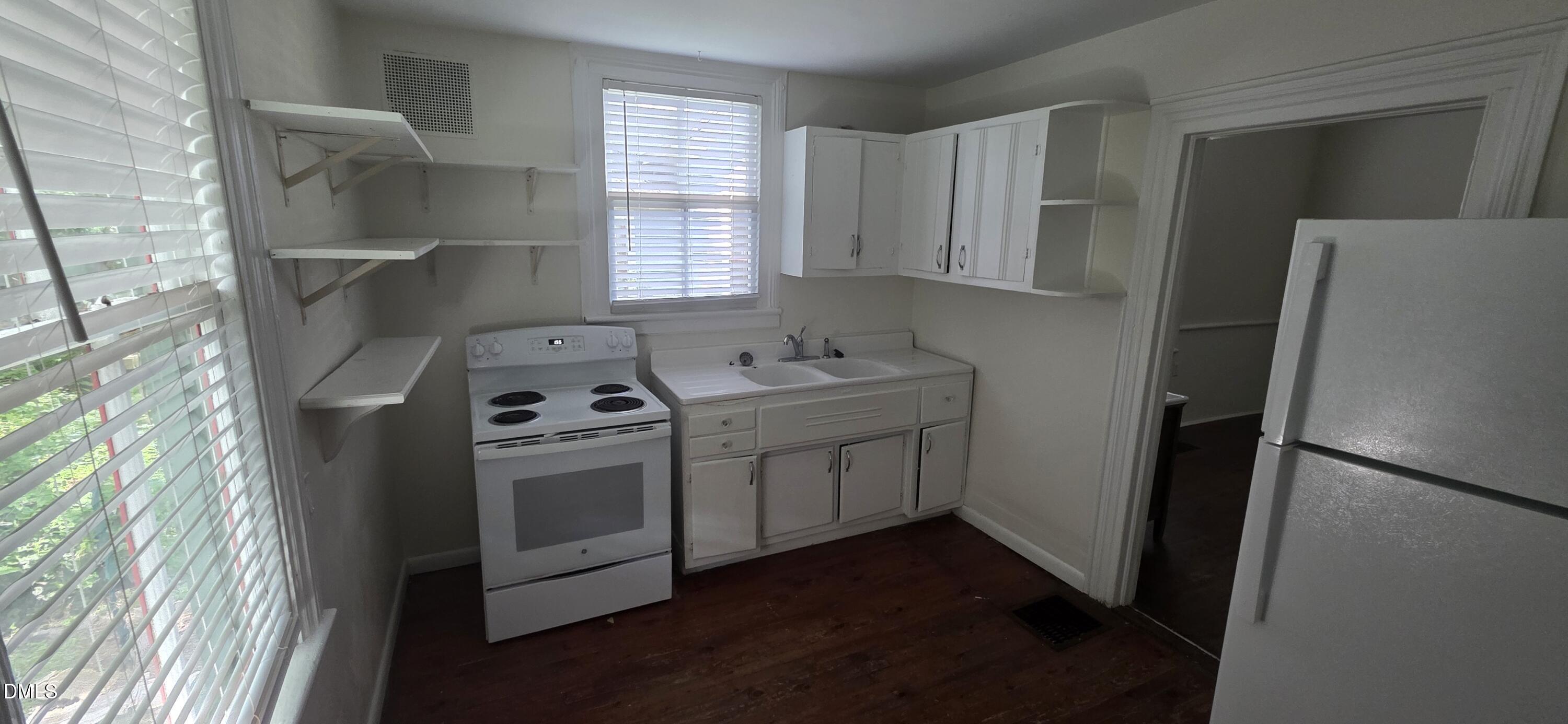 509 North East Street Raleigh, NC 27604 - Photo 14 of 18 a kitchen with a refrigerator sink and cabinets