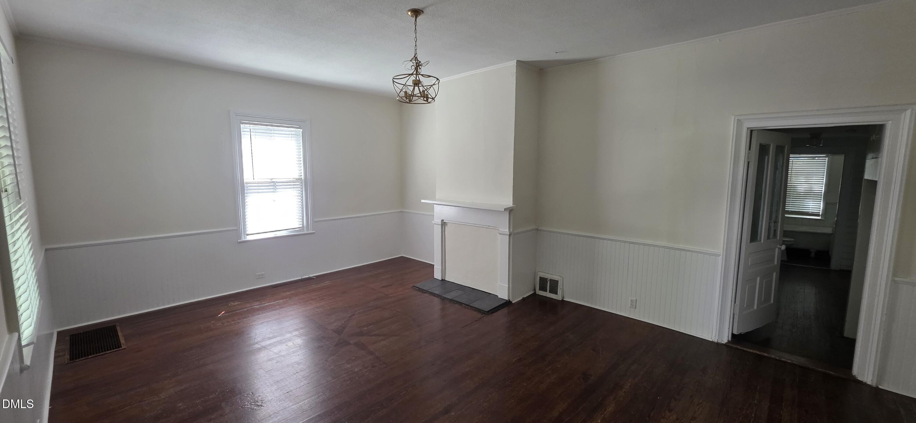 509 North East Street Raleigh, NC 27604 - Photo 8 of 18 an empty room with wooden floor and windows