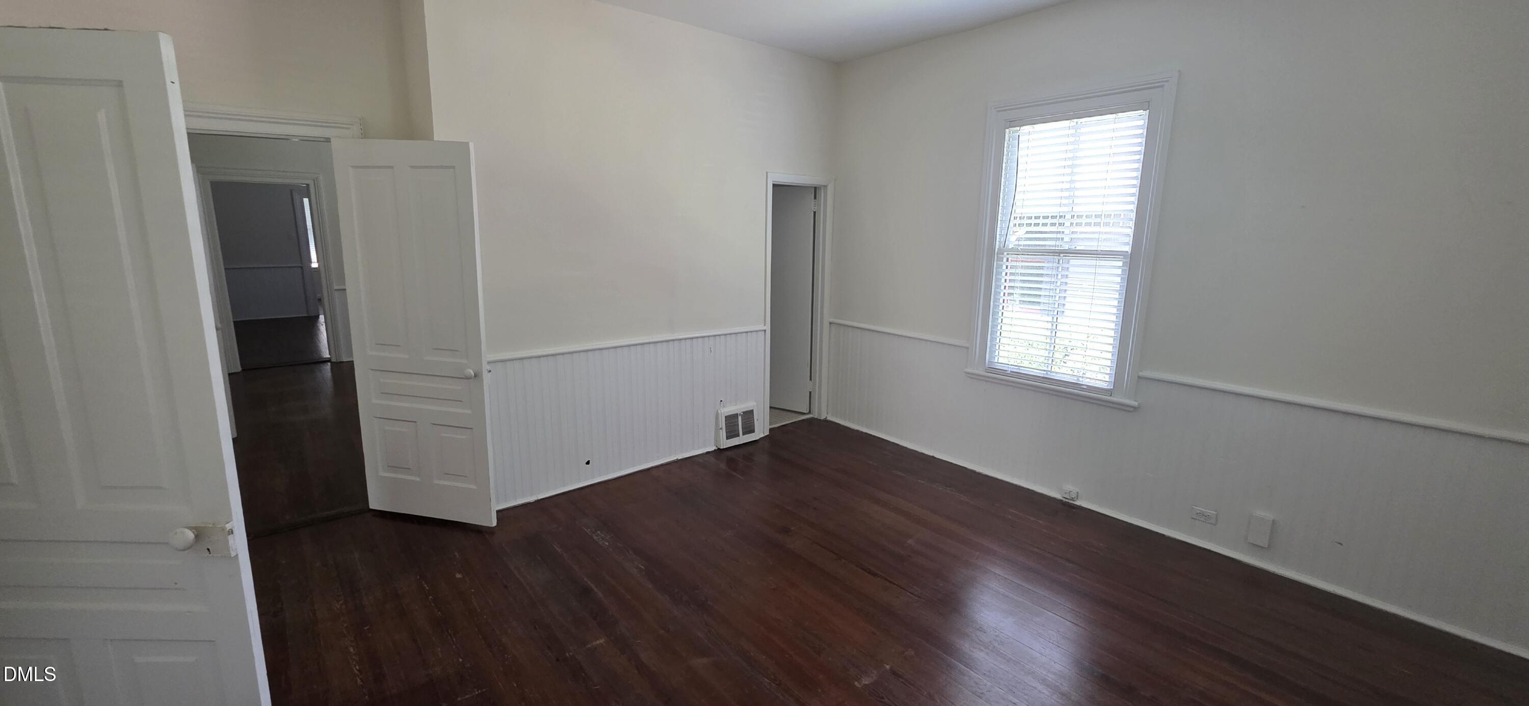 509 North East Street Raleigh, NC 27604 - Photo 10 of 18 an empty room with wooden floor closet and windows
