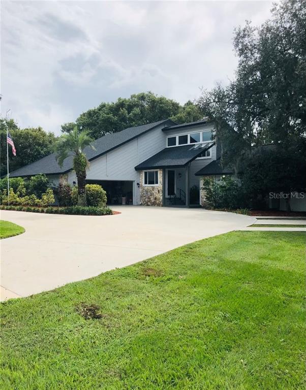1670 Neptune Road Kissimmee, FL 34744 - Photo 1 of 1 a front view of a house with a yard