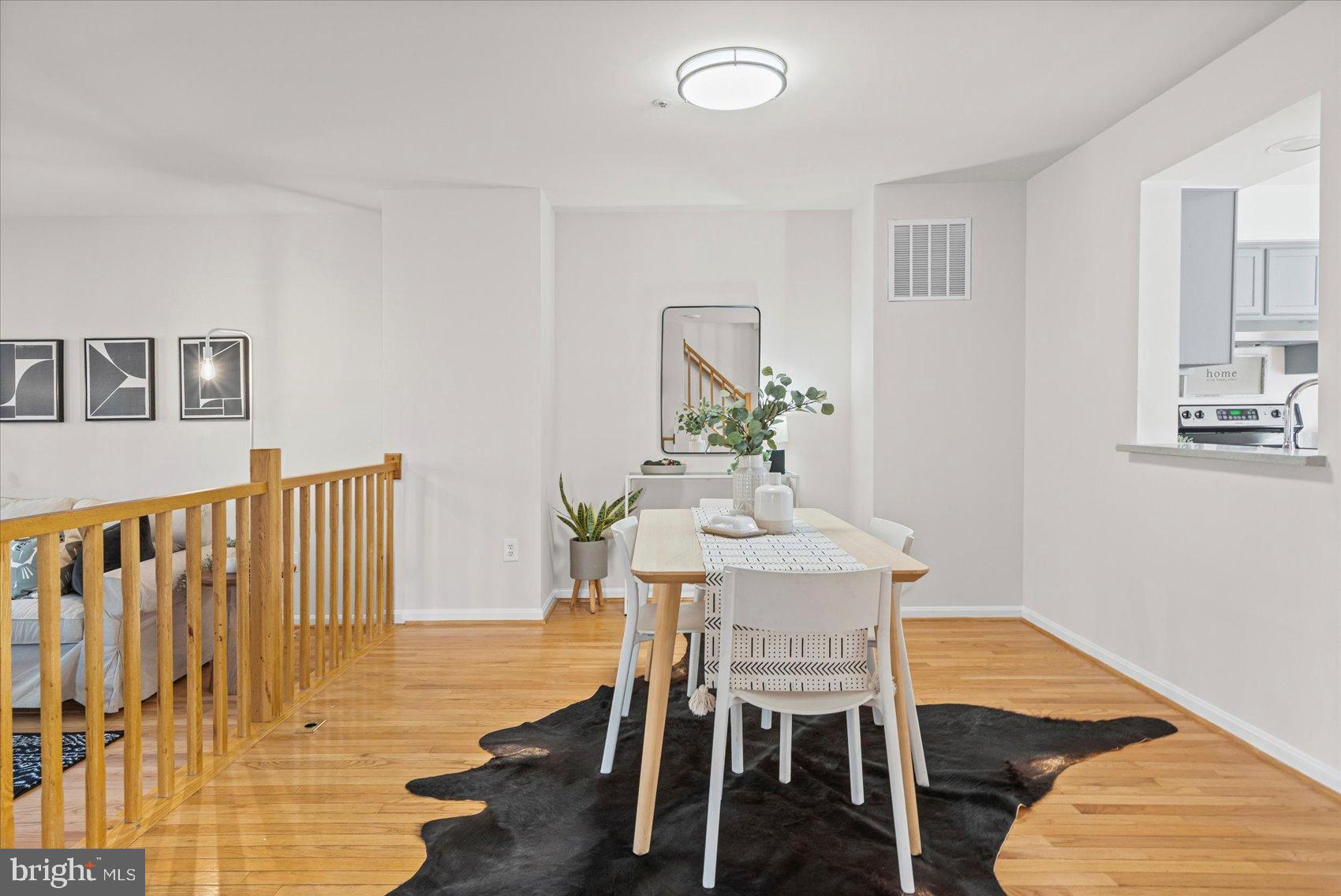 9317 Dortmund Court Laurel, MD 20708 - Photo 12 of 50 a view of a dining room with furniture and wooden floor