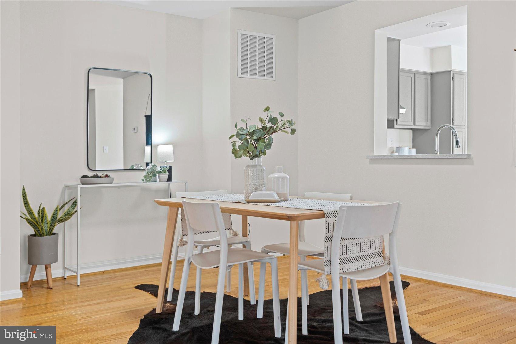 9317 Dortmund Court Laurel, MD 20708 - Photo 13 of 50 a view of a dining room with furniture and wooden floor