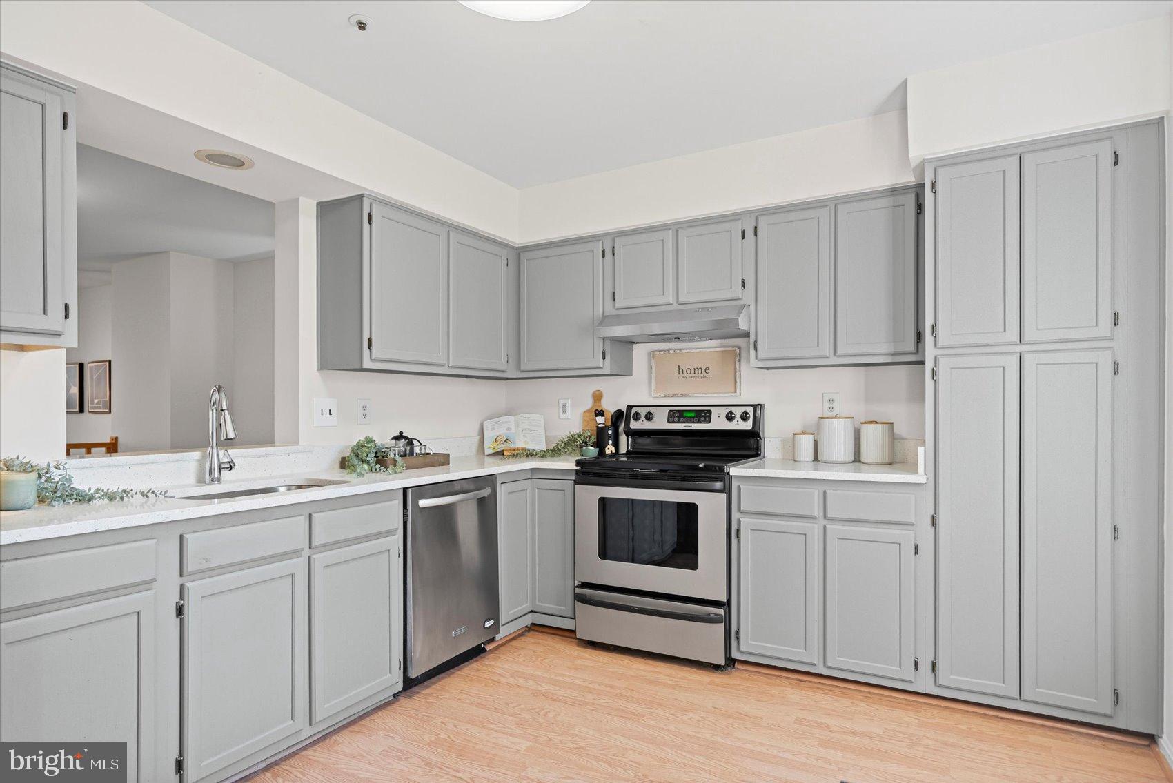 9317 Dortmund Court Laurel, MD 20708 - Photo 16 of 50 a kitchen with white cabinets stainless steel appliances and sink