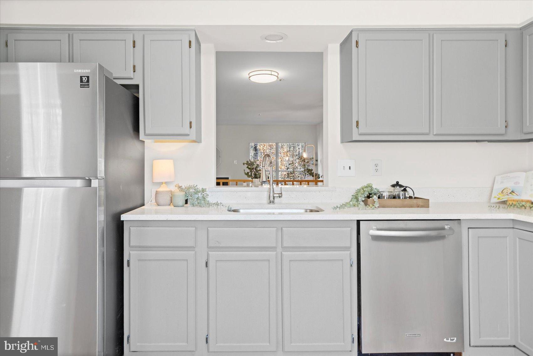 9317 Dortmund Court Laurel, MD 20708 - Photo 17 of 50 a kitchen with white cabinets and refrigerator