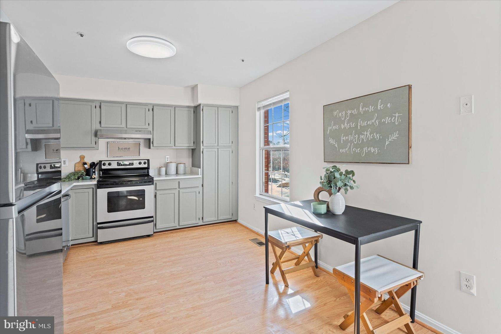 9317 Dortmund Court Laurel, MD 20708 - Photo 19 of 50 a kitchen with granite countertop a stove a sink and a refrigerator
