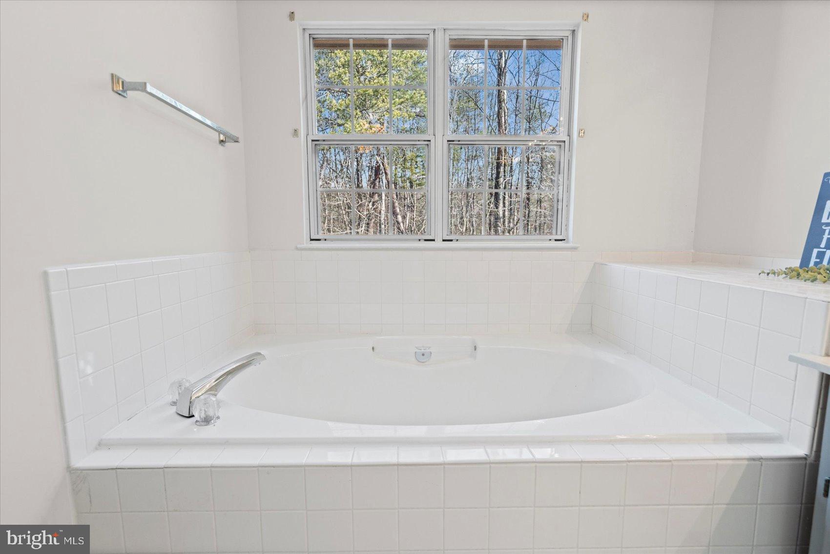 9317 Dortmund Court Laurel, MD 20708 - Photo 29 of 50 a white bath tub sitting next to a window