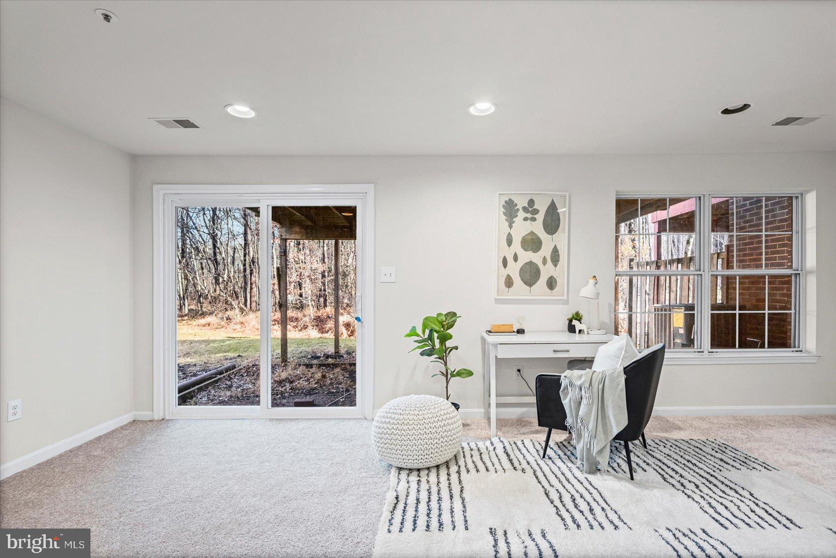 9317 Dortmund Court Laurel, MD 20708 - Photo 38 of 50 a living room with furniture a window and a table