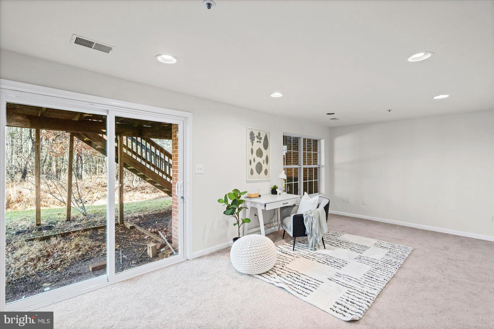 9317 Dortmund Court Laurel, MD 20708 - Photo 39 of 50 a room with furniture and a potted plant