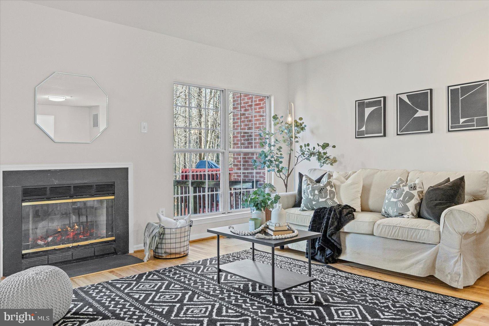 9317 Dortmund Court Laurel, MD 20708 - Photo 5 of 50 a living room with furniture and a fireplace