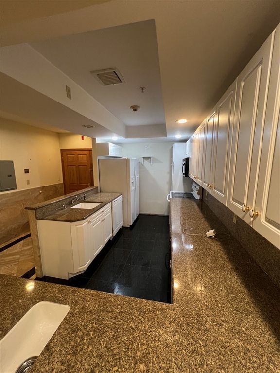 373 Highland Avenue, Unit 308 Somerville, MA 02144 - Photo 2 of 9 a view of a room with wooden floor