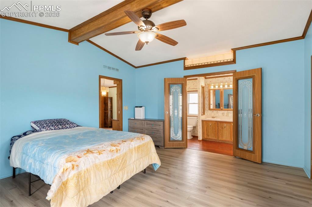 13335 Gymkhana Road Peyton, CO 80831 - Photo 27 of 38 Vaulted ceiling featuring exposed wood beams and a ceiling fan with integrated lighting
